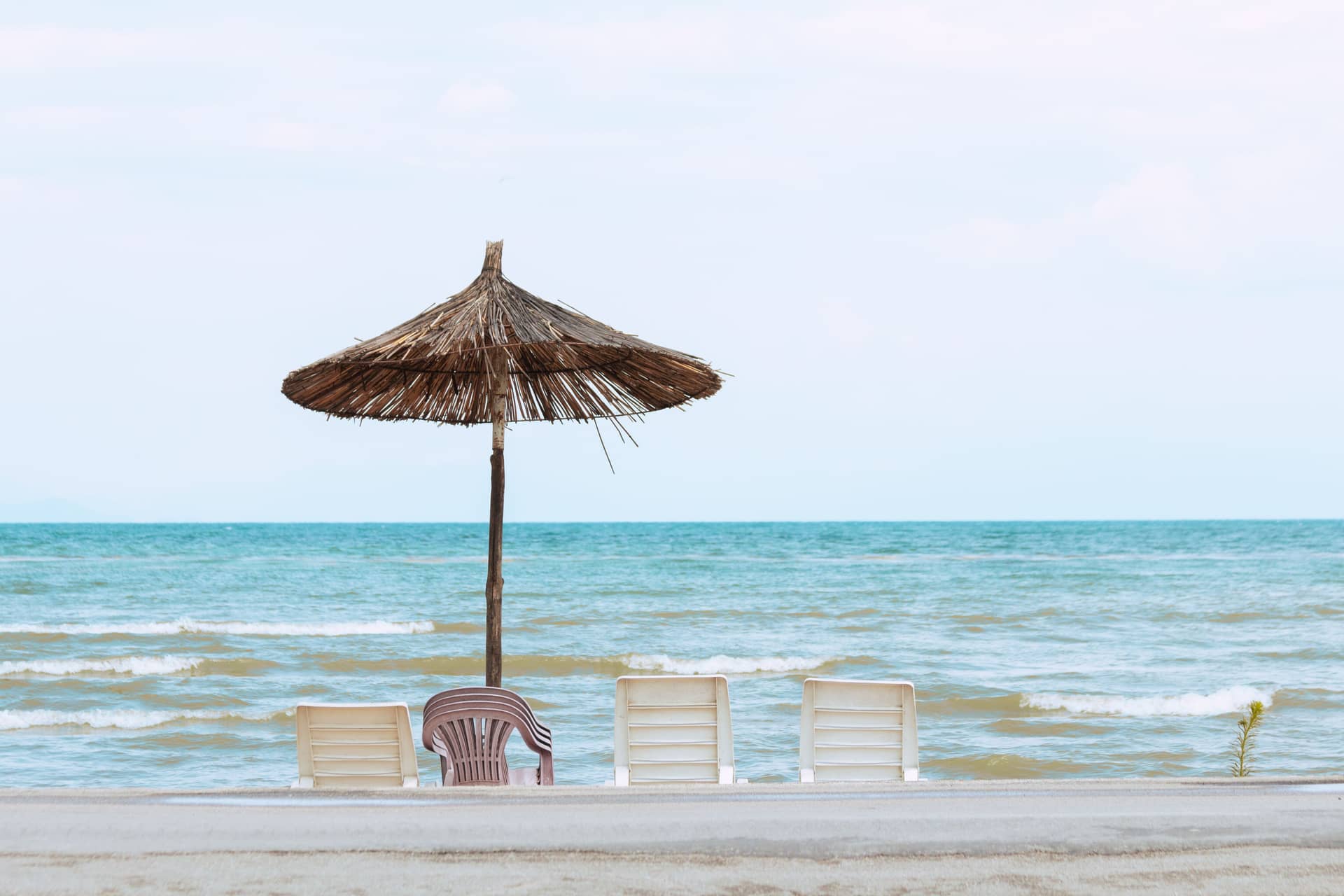 Beach umbrella and chairs facing the sea on the Albanian coast