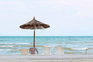 Beach umbrella and chairs facing the sea on the Albanian coast